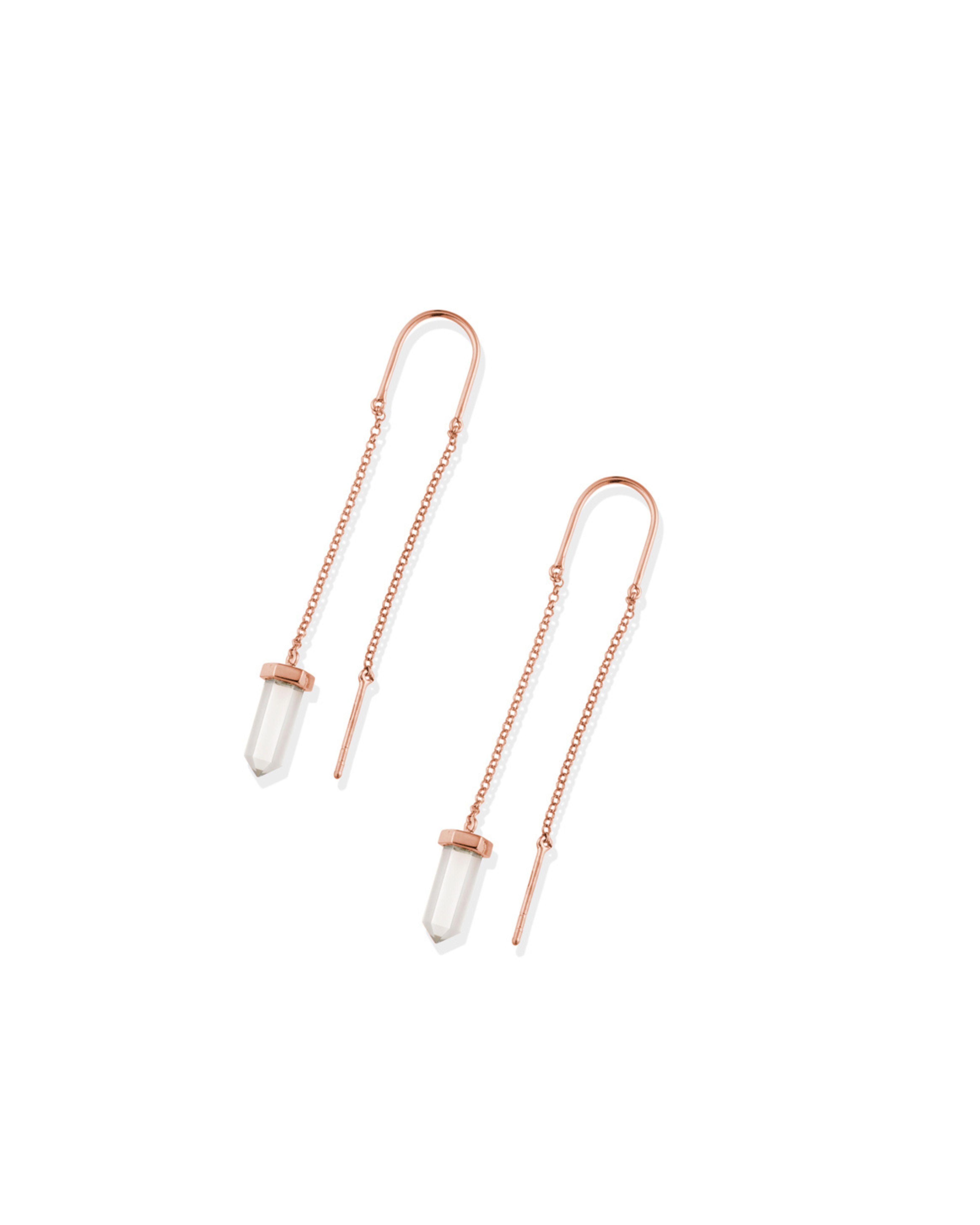 Pair of rose gold threader earrings with clear gemstones on a white background