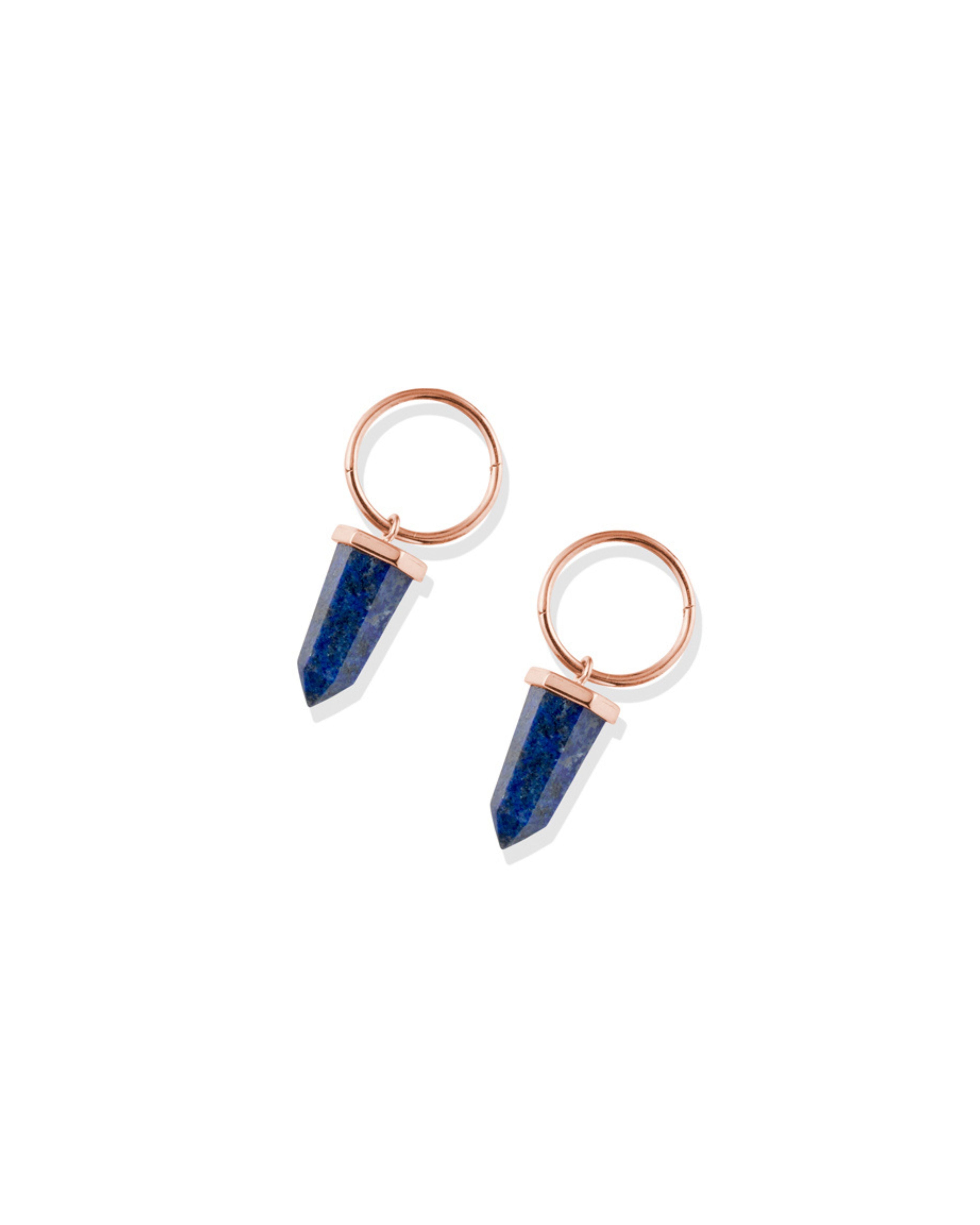 Pair of earrings with lapis lazuli and rose gold metal on a white background
