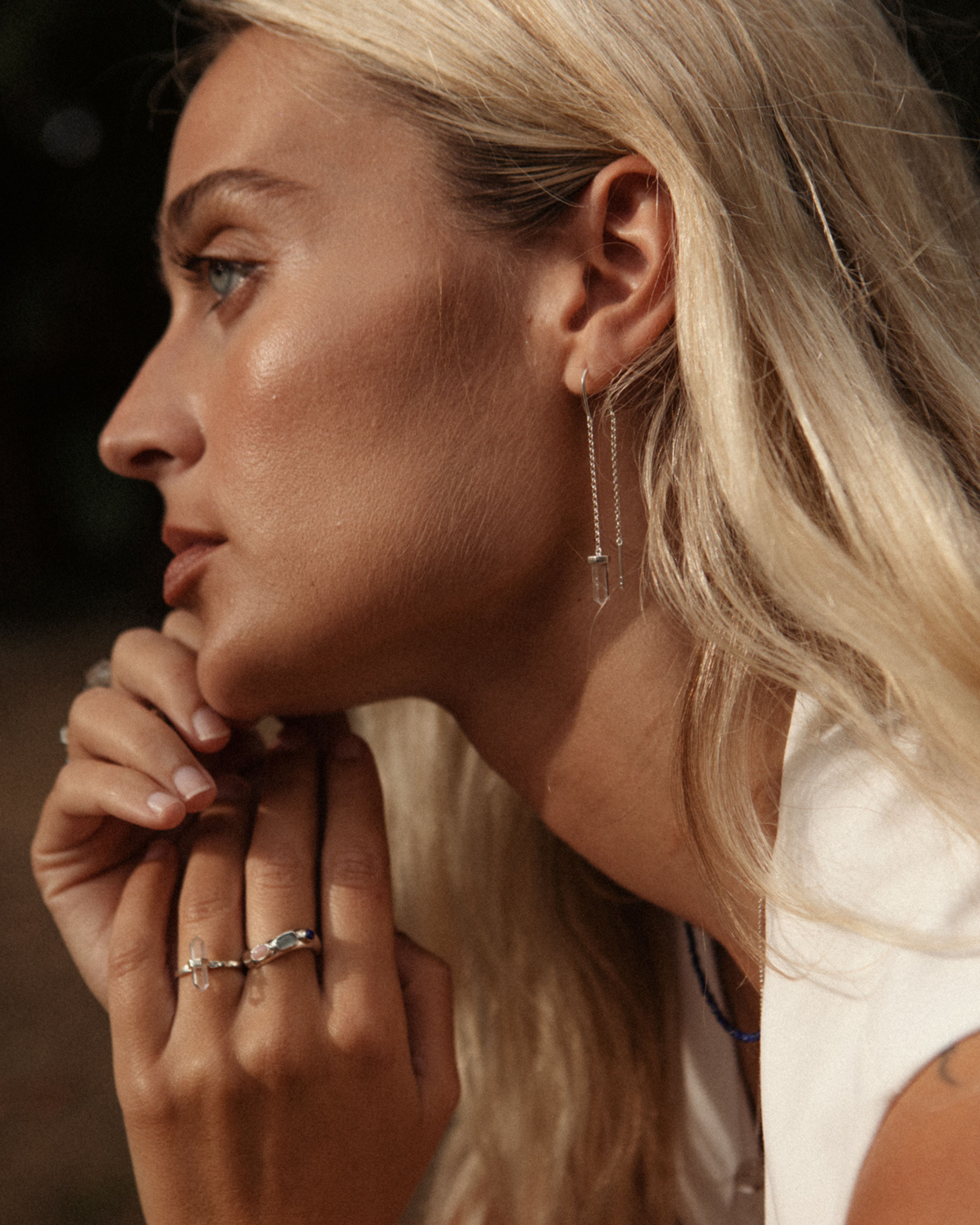Model Wearing Gold earrings with Clear Quartz