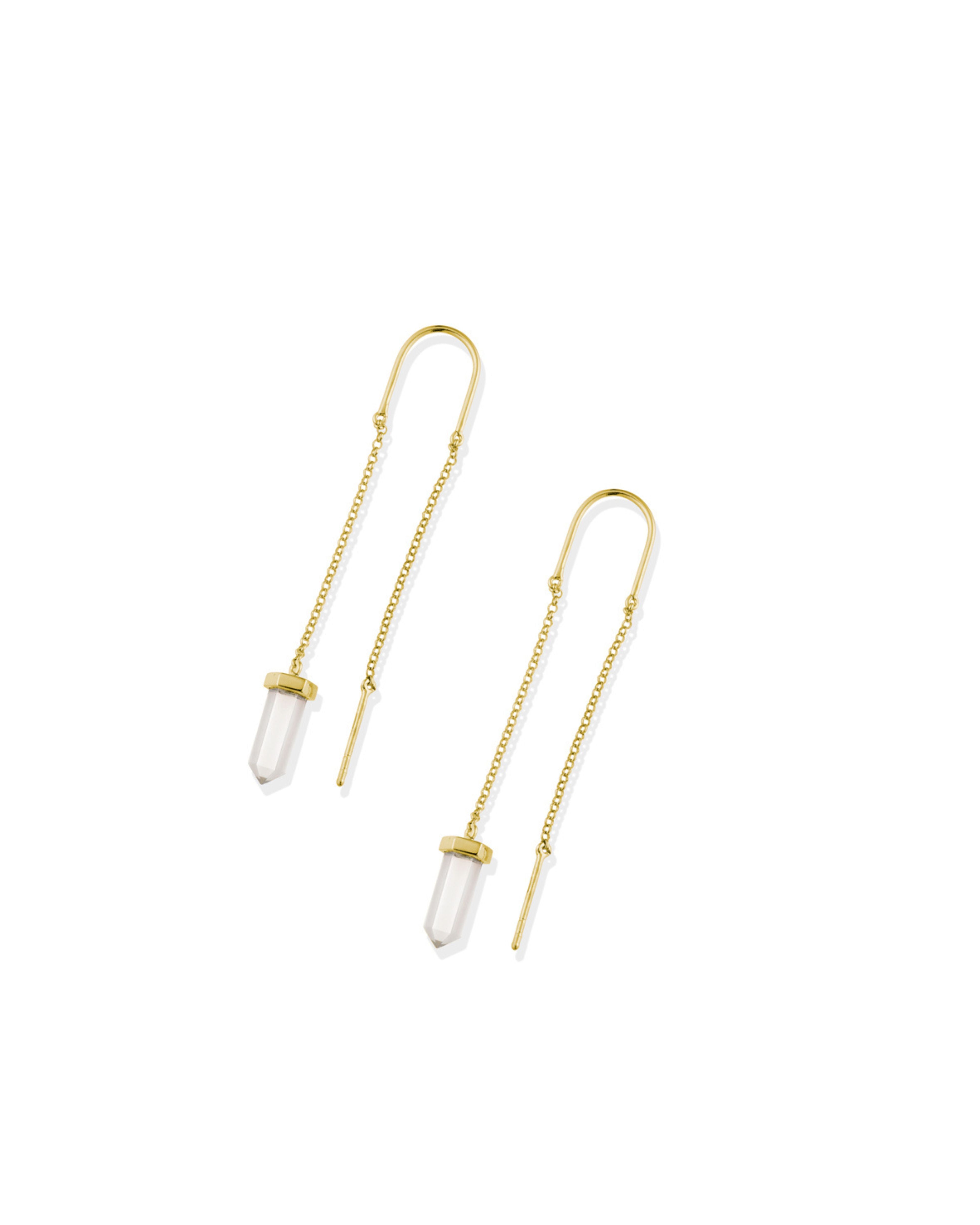 Gold chain earrings with clear quartz on a white background